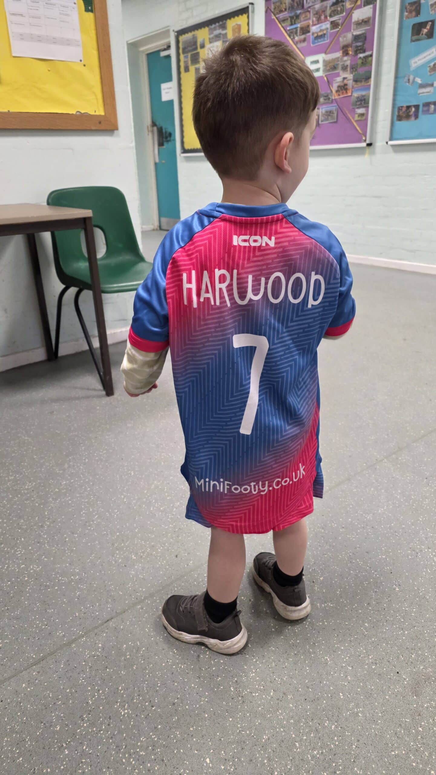 A child wearing a Mini Footy kit
